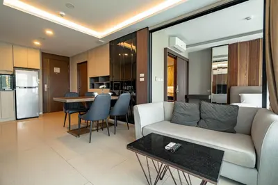 a living room with a couch and a table at Suite Calista 2BRView JacuzziMida Grande Surin in Surin Beach