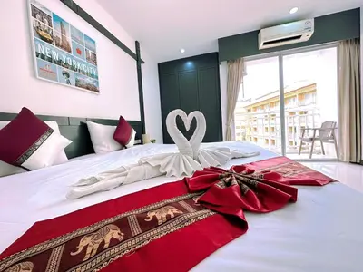 a bedroom with a bed with a heart decoration on it at Hotel Baya Phuket in Patong Beach