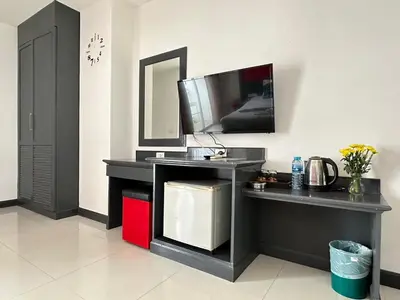 a room with a counter with a sink and a tv at Hotel Baya Phuket in Patong Beach