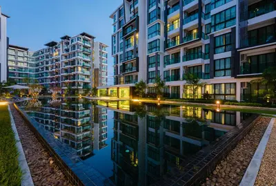 a city with tall buildings next to a body of water at Wyndham Phuket Airport in Nai Yang Beach