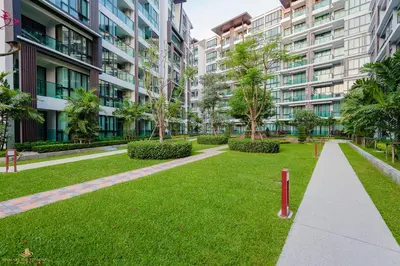a park in front of some tall buildings at Wyndham Phuket Airport in Nai Yang Beach