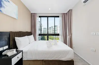 a hotel room with a bed and a window at Wyndham Phuket Airport in Nai Yang Beach