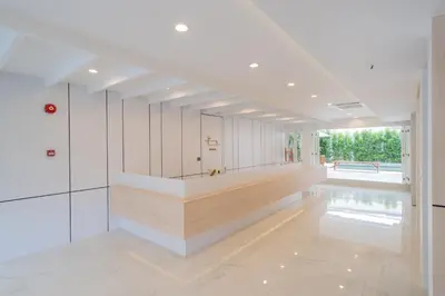 a large room with white walls and a long hallway at Bedline Hotel - SHA Certified in Phuket Town