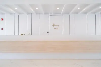 an empty room with white walls and a wooden floor at Bedline Hotel - SHA Certified in Phuket Town