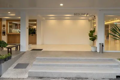 a lobby of a building with stairs and plants at Bedline Hotel - SHA Certified in Phuket Town