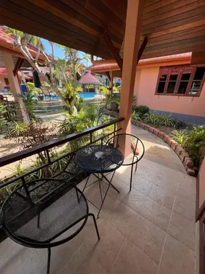 a patio with two chairs and a table at The Pace Phuket Boutique Resort in Rawai Beach