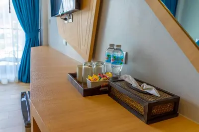 a kitchen counter with a tray of food and water bottles at Golden Paradise Hotel - SHA PLUS in Karon Beach