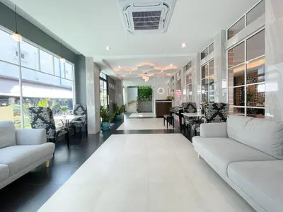 a lobby with couches and tables in a building at Le Cartier in Patong Beach
