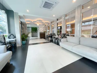 a living room with a couch and a table at Le Cartier in Patong Beach