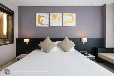 a bedroom with a large white bed with pillows at ✪✪✪✪✪ Patong Beachfront Studio Rooftop Pool Skybar in Patong Beach