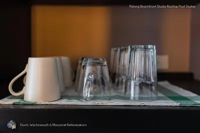 a group of glasses sitting on top of a table at ✪✪✪✪✪ Patong Beachfront Studio Rooftop Pool Skybar in Patong Beach