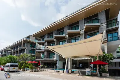 a large apartment building with awning in front of it at ✪✪✪✪✪ Patong Beachfront Studio Rooftop Pool Skybar in Patong Beach