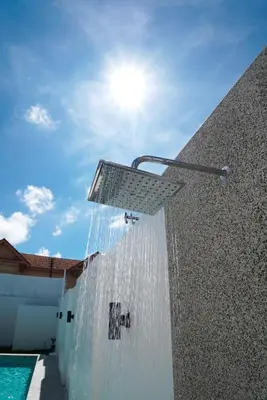a water fountain on the side of a building at BAANKAAN Pool Villa 1 in Ban Khlong Haeng