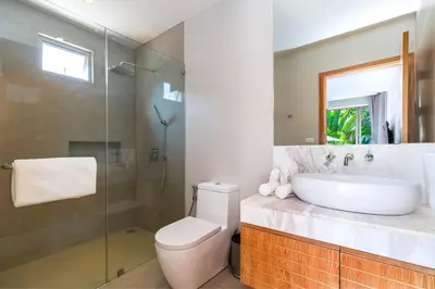 a bathroom with a toilet and a sink and a shower at Sunny 3BR Villa with Private Pool at Bangtao Beach in Bang Tao Beach