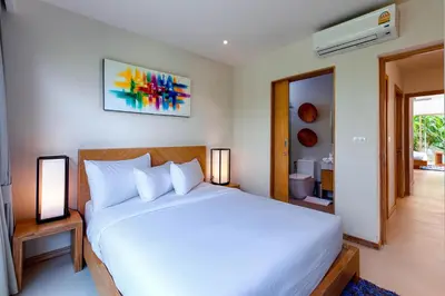 a bedroom with a large white bed with two lamps at Sunny 3BR Villa with Private Pool at Bangtao Beach in Bang Tao Beach
