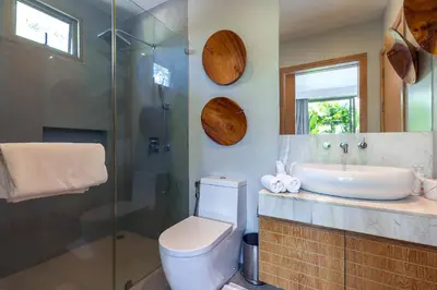a bathroom with a toilet and a sink and a shower at Sunny 3BR Villa with Private Pool at Bangtao Beach in Bang Tao Beach
