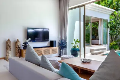 a living room with a couch and a tv at Sunny 3BR Villa with Private Pool at Bangtao Beach in Bang Tao Beach