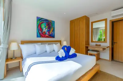 a bedroom with a bed with a blue stuffed animal on it at Sunny 3BR Villa with Private Pool at Bangtao Beach in Bang Tao Beach