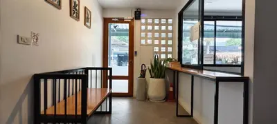 a hallway with a staircase with a bench and a window at B3 HOUSE in Kamala Beach