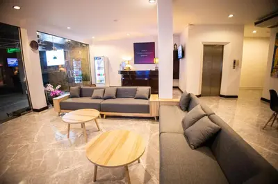 a living room with two couches and a table at Rico's Patong Hotel in Patong Beach