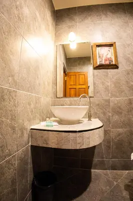 a bathroom with a sink and a mirror at Rico's Patong Hotel in Patong Beach