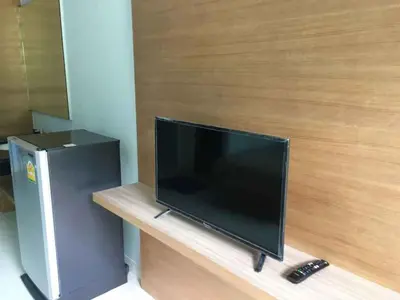 a flat screen tv sitting on top of a counter at Phumi Resort in Thalang