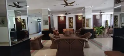 a lobby with a table and chairs and ceiling fans at Patong beach apartment for up to 4 person in Patong Beach