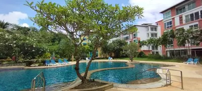 a swimming pool with a tree in the middle at Patong beach apartment for up to 4 person in Patong Beach