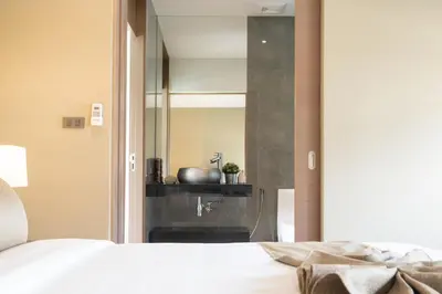 a bedroom with a mirror and a sink at Blue Coral Luxury Villa - Tropical Modern Living in Phuket Town