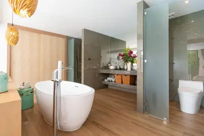 a bathroom with a white tub and a toilet at Blue Coral Luxury Villa - Tropical Modern Living in Phuket Town