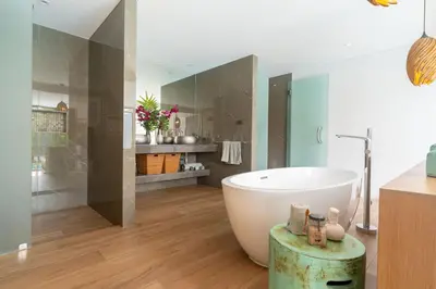 a bathroom with a large tub and a sink at Blue Coral Luxury Villa - Tropical Modern Living in Phuket Town