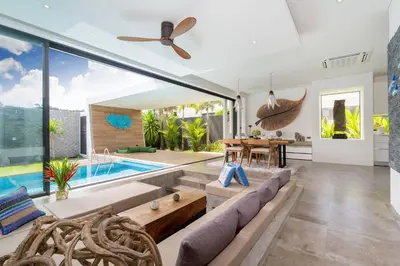 an open living room with a pool and a table at Blue Coral Luxury Villa - Tropical Modern Living in Phuket Town