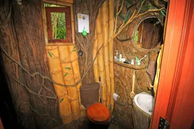 a bathroom with a tree mural on the wall at Treehouse Holidays-Garden View in Ko Yao Noi
