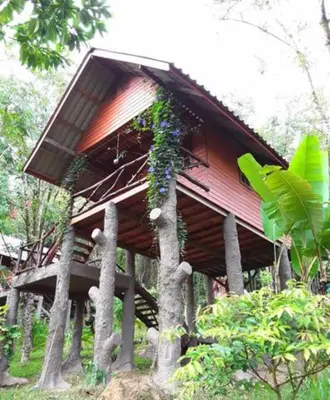 a small building with trees in front of it at Treehouse Holidays-Garden View in Ko Yao Noi