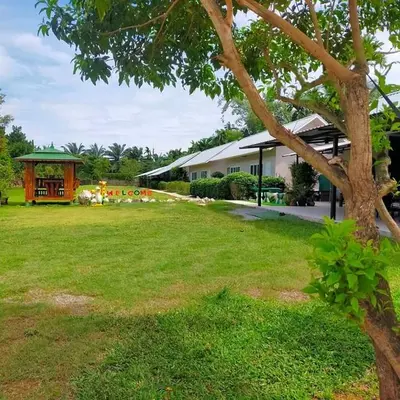 a large yard with a building and a gazebo at Davy Cottage Phuket in Thalang