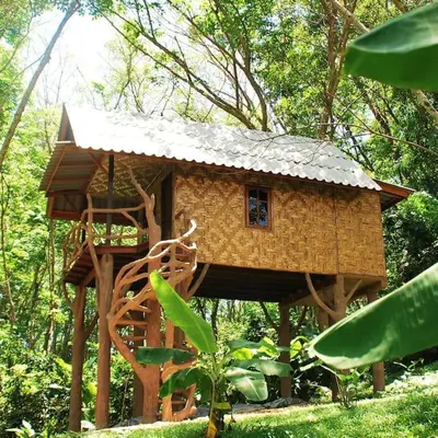 a small tree house in the middle of a forest at Treehouse Holidays-Love Nest in Ko Yao Noi