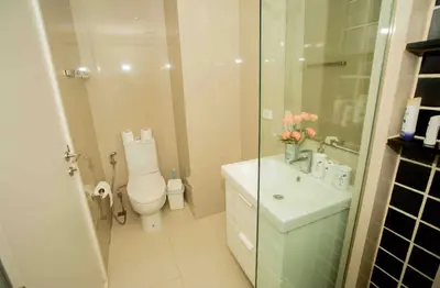 a bathroom with a toilet and a sink and a shower at The Deck Patong in Patong Beach