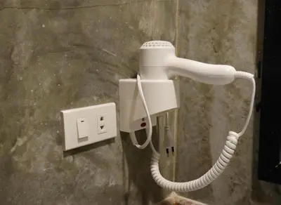 a white phone is plugged into a wall at Andaman Resort in Phi Phi Don