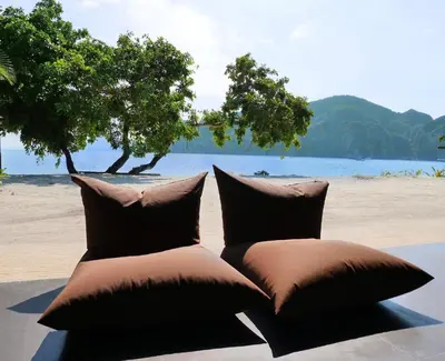 a couple of pillows sitting on top of a beach at Andaman Resort in Phi Phi Don