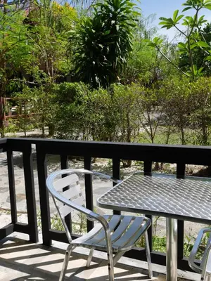 a table and two chairs and a table and a table and chairs at Andaman Resort in Phi Phi Don