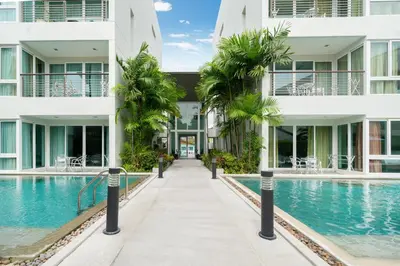 an external view of a building with a swimming pool at Holiday apartment at Palms, 100 meters to beach in Kamala Beach