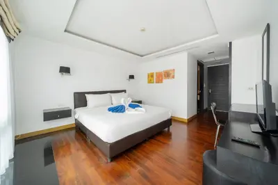 a bedroom with a bed and a flat screen tv at Holiday apartment at Palms, 100 meters to beach in Kamala Beach