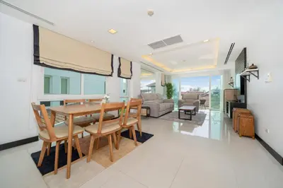 a dining room and living room with a table and chairs at Holiday apartment at Palms, 100 meters to beach in Kamala Beach