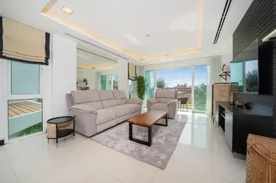 a living room with a couch and a table at Holiday apartment at Palms, 100 meters to beach in Kamala Beach