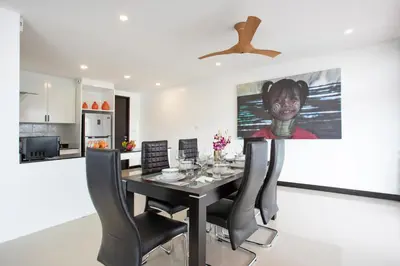 a dining room with a black table and black chairs at Lovely pool villa 2 bedrooms in rawai with seaview in Ban Saiyuan (1)