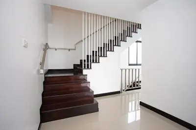 a staircase in a house with white walls and wooden floors at Lovely pool villa 2 bedrooms in rawai with seaview in Ban Saiyuan (1)