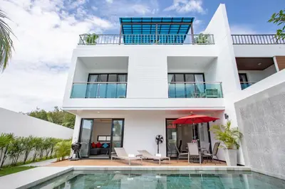 a villa with a swimming pool and a house at Lovely pool villa 2 bedrooms in rawai with seaview in Ban Saiyuan (1)