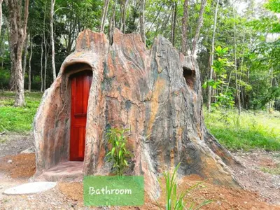 a large tree stump with a door in it at Treehouse Holidays-Little house in Ko Yao Noi