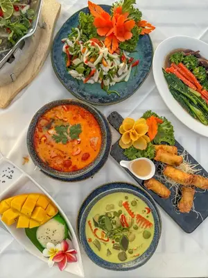 a table topped with plates of food and bowls of food at Royal Yao Yai Island Beach Resort in Ko Yao Yai