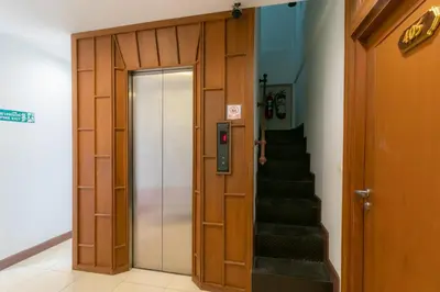 a door leading to a hallway with a staircase at Lotus Hotel Patong in Patong Beach